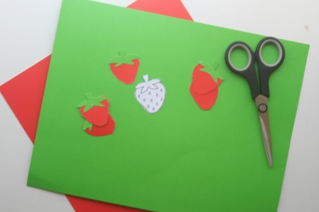Cut out strawberries using red and green craft paper and a stencil you can find online. 